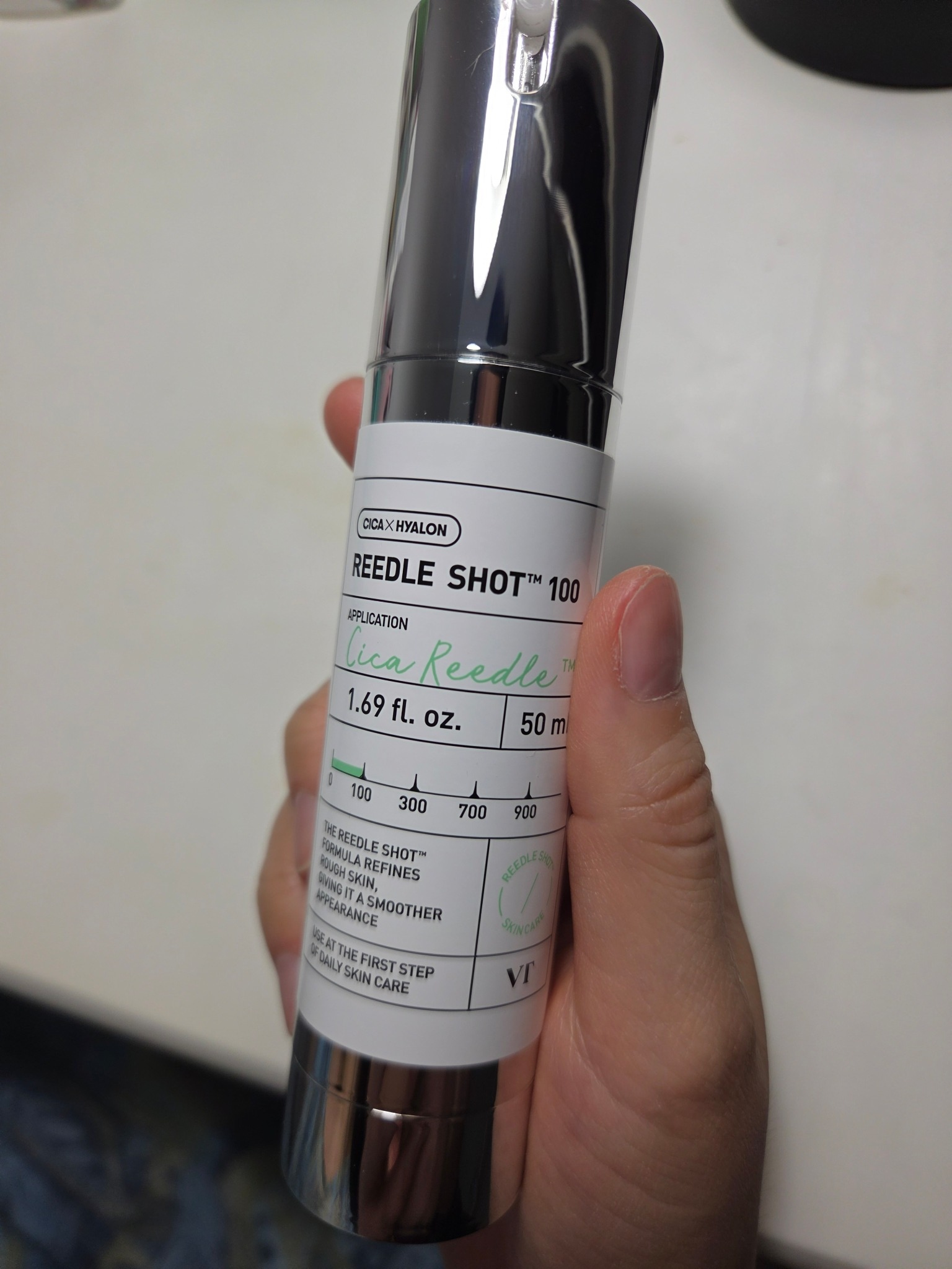 VT CICA Reedle Shot 100 bottle held in hand, showing the front label
